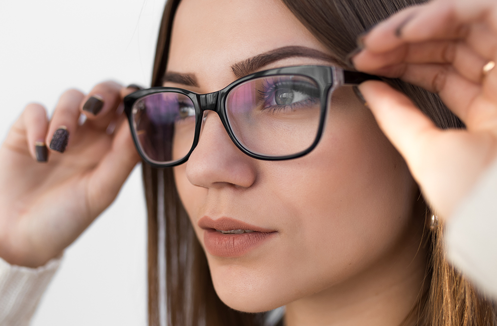 Woman try on glasses for good vision